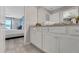 Bright bathroom featuring a granite countertop, white cabinets, and an open view to the bedroom at 720 Gardenia Ln, Davenport, FL 33897