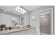 Bright bathroom featuring a granite countertop, white cabinets, and tile surround shower with door at 720 Gardenia Ln, Davenport, FL 33897