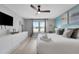 Bright bedroom features a king bed, dresser, coastal decor, and lots of natural light at 720 Gardenia Ln, Davenport, FL 33897