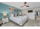 Comfortable bedroom with king bed, stylish decor, ceiling fan, and light wood floors at 720 Gardenia Ln, Davenport, FL 33897