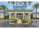 Stunning clubhouse entrance with blue roofs framed by palm trees and manicured landscaping at 720 Gardenia Ln, Davenport, FL 33897