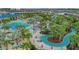 Aerial view of the community amenities featuring lazy river, pool, palms, and lounge areas at 720 Gardenia Ln, Davenport, FL 33897