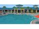 Beautiful community pool with ample seating and palm trees for a resort-like experience at 720 Gardenia Ln, Davenport, FL 33897