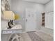 Welcoming foyer featuring a decorative table with a lamp and a built-in storage bench with woven baskets at 720 Gardenia Ln, Davenport, FL 33897