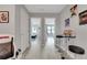 Bright hallway featuring modern decor, adjacent bedrooms, and stylish furnishings at 720 Gardenia Ln, Davenport, FL 33897