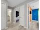 Neutral-toned hallway with open doorways leading to adjacent rooms and bath at 720 Gardenia Ln, Davenport, FL 33897