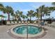 Relaxing hot tub surrounded by lounge chairs and swaying palm trees, perfect for leisure at 720 Gardenia Ln, Davenport, FL 33897