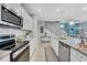 Modern kitchen with stainless steel appliances, white cabinets, granite countertops and tile backsplash at 720 Gardenia Ln, Davenport, FL 33897