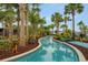 Lush lazy river winding through a tropical landscape, perfect for relaxation and recreation at 720 Gardenia Ln, Davenport, FL 33897