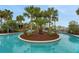 Scenic lazy river with island landscaping offering a tranquil escape in a lush setting at 720 Gardenia Ln, Davenport, FL 33897