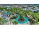 Aerial view of a winding lazy river surrounded by lush landscaping and palm trees at 720 Gardenia Ln, Davenport, FL 33897