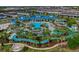 Aerial view of the lazy river winding through lush landscaping with resort pool at 720 Gardenia Ln, Davenport, FL 33897