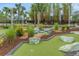 A well-manicured mini golf course with lush greenery and decorative rock features at 720 Gardenia Ln, Davenport, FL 33897