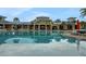 Large swimming pool with sun loungers and umbrellas, ideal for relaxation at 720 Gardenia Ln, Davenport, FL 33897