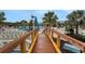 Inviting pool deck with a bridge leading to a large swimming area and lounge chairs at 720 Gardenia Ln, Davenport, FL 33897