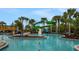 Resort-style pool area with slides, sun loungers, and tropical landscaping for a relaxing getaway at 720 Gardenia Ln, Davenport, FL 33897