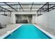 Beautiful backyard pool area with black metal screening ensures privacy and relaxation at 720 Gardenia Ln, Davenport, FL 33897