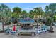 Charming poolside Rumbreakers bar surrounded by palm trees and seating for relaxing and socializing at 720 Gardenia Ln, Davenport, FL 33897