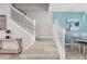 Elegant staircase with white railing, neutral-colored walls, and plenty of natural light at 720 Gardenia Ln, Davenport, FL 33897