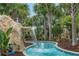 Picturesque lazy river with a rock waterfall and lush greenery, providing a serene atmosphere at 720 Gardenia Ln, Davenport, FL 33897