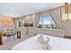 Spacious bedroom featuring a king bed, sitting area, flat-screen TV, and abundant natural light at 7461 Bleecker Ln, Kissimmee, FL 34747