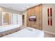 Inviting bedroom featuring two beds, a flat-screen TV, and an en-suite bathroom with modern accents at 7461 Bleecker Ln, Kissimmee, FL 34747