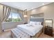Comfortable bedroom showcasing a plush king bed, elegant decor, and serene views of the outdoors at 7461 Bleecker Ln, Kissimmee, FL 34747