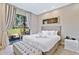 Serene bedroom featuring a plush bed and large windows, offering natural light at 7461 Bleecker Ln, Kissimmee, FL 34747