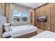Bright bedroom featuring two twin beds, a flat-screen TV, and a window offering outdoor views at 7461 Bleecker Ln, Kissimmee, FL 34747