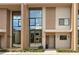 Modern townhome with large windows, neutral tones, and tasteful landscaping at 7461 Bleecker Ln, Kissimmee, FL 34747