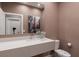 Modern powder room with a floating vanity, stylish fixtures, and elegant design for a luxurious feel at 7461 Bleecker Ln, Kissimmee, FL 34747