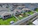 Aerial view of the home showing solar panels, the landscaped yard and covered back patio at 7639 Agrigento St, Clermont, FL 34714
