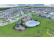 Aerial view of community pool area with playground in new neighborhood at 7639 Agrigento St, Clermont, FL 34714