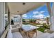 Inviting covered back patio with patio furniture overlooking the landscaped backyard at 7639 Agrigento St, Clermont, FL 34714