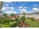 Landscaped backyard with hammock, seating area and lush tropical plants at 7639 Agrigento St, Clermont, FL 34714