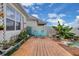 Charming backyard deck with cozy seating and landscaped garden at 7639 Agrigento St, Clermont, FL 34714