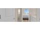 View into bathroom, with a glass-doored shower, and a bedroom beyond at 7639 Agrigento St, Clermont, FL 34714
