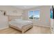 This bedroom features a bright window, light wood floors, and a modern rustic bedframe at 7639 Agrigento St, Clermont, FL 34714