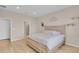 Bright bedroom with light wood floors and a rustic bedframe, illuminated by recessed lighting at 7639 Agrigento St, Clermont, FL 34714