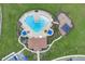 Aerial view showcasing a community pool and recreation area surrounded by lush green space with ample lounge chairs at 7639 Agrigento St, Clermont, FL 34714