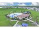 Aerial view of community pool area with clubhouse, lounge chairs and playground at 7639 Agrigento St, Clermont, FL 34714