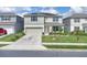 Beautiful two-story home with a manicured lawn, a two-car garage, solar panels, and inviting curb appeal at 7639 Agrigento St, Clermont, FL 34714