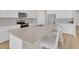 Modern kitchen featuring white cabinets, stainless steel appliances, and a center island with seating at 7639 Agrigento St, Clermont, FL 34714