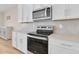 Bright kitchen features stainless steel appliances, quartz countertops, and white cabinets at 7639 Agrigento St, Clermont, FL 34714