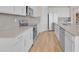 Modern kitchen featuring stainless appliances, white cabinets, and hardwood floors at 7639 Agrigento St, Clermont, FL 34714