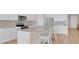 Modern kitchen featuring white cabinets, stainless steel appliances, and a center island with seating at 7639 Agrigento St, Clermont, FL 34714