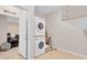 Laundry room with stacked washer and dryer and white trim at 7639 Agrigento St, Clermont, FL 34714