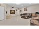 Large living room with leather furniture and ample entertaining space at 7639 Agrigento St, Clermont, FL 34714
