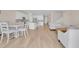 Open-concept living space with a kitchen, dining area, and living room featuring hardwood floors and neutral tones at 7639 Agrigento St, Clermont, FL 34714