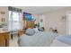 Bright main bedroom featuring a large television and natural light at 7639 Agrigento St, Clermont, FL 34714